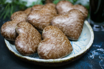 Christmas gingerbreads in the form of heart. Christmas composition on the background of fir-tree branches