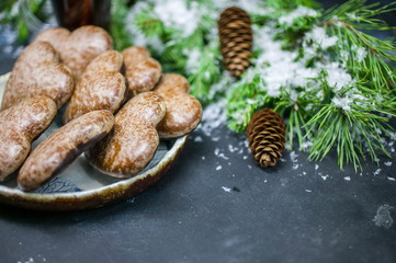 Christmas gingerbreads in the form of heart. Christmas composition on the background of fir-tree branches