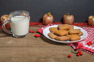 Biscuits, milk, red napkin, Christmas decor with free space for text.