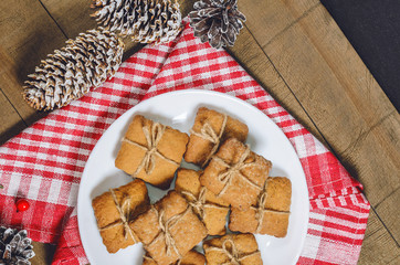 Biscuits, red berries, bumps, gifts, Christmas decor with free space for text. Top view