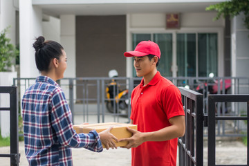 Young man Delivering Package to customer at home. Delivery