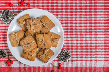 Cookies and Christmas decor on a red napkin top view