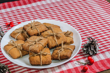 Cookies and Christmas decor on a red napkin top view