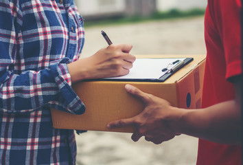 Young man Delivering Package to customer at home. Delivery