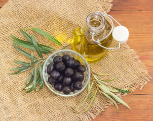 Black olives, olive oil and olive branches