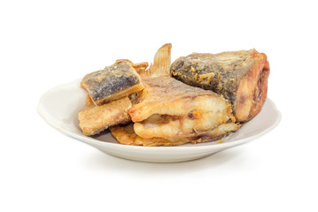 Fried pieces of carp on dish on a white background