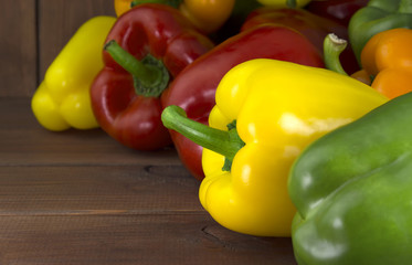 Juicy beautiful Bulgarian pepper on a wooden background