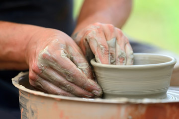 Potter making ceramic pot on the pottery wheel