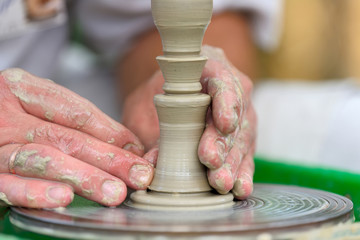 Potter making ceramic pot on the pottery wheel