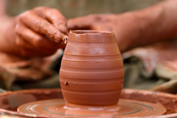 Potter making ceramic pot on the pottery wheel