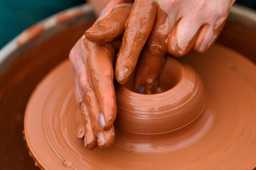 Potter making ceramic pot on the pottery wheel