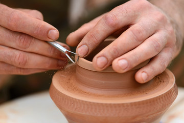 Potter making ceramic pot on the pottery wheel