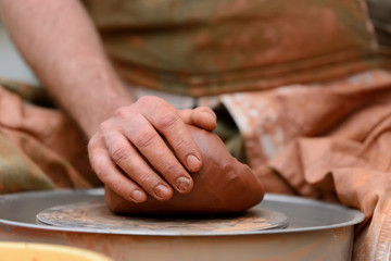 Potter making ceramic pot on the pottery wheel