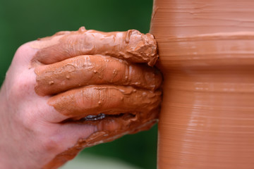 Potter making ceramic pot on the pottery wheel