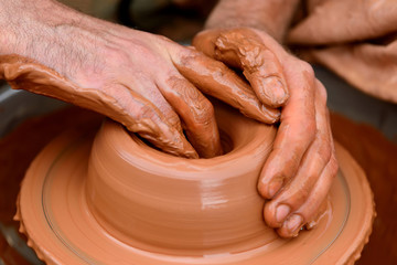 Potter making ceramic pot on the pottery wheel