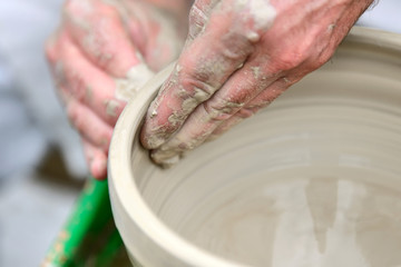 Potter making ceramic pot on the pottery wheel