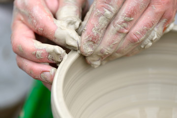 Potter making ceramic pot on the pottery wheel