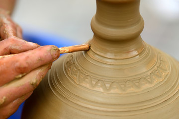 Potter making ceramic pot on the pottery wheel