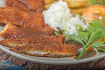 Chicken chop with vegetable and black pepper sauce in plate over wooden table