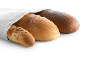 Three kinds of bread wrapped together in a paper bag for sale isolated on white copyspace retail food market shop store bakery baking recipe sale discount nutrition concept.