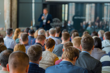 Audience listens to the lecturer at the conference hall