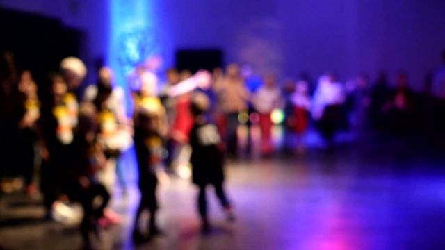 4K footage. The dance floor, defocused silhouettes of people, children and adults.