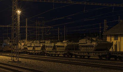 Fototapeta na wymiar Train with army tanks in autumn night in Veseli nad Luznici