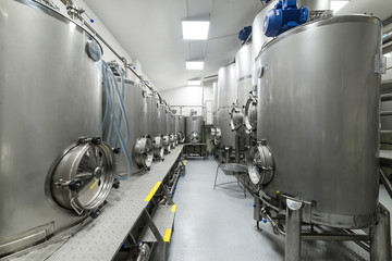 Shop with large metal tanks, modern production of beverages.