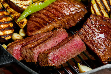 slicing delicious grilled meat with vegetable, close up