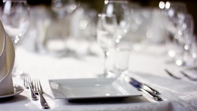 Shot of an empty plate and wine glasses on table at restaurant