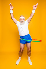 Emotional cool cheerful excited crazy funny fooling playful gymnast grandpa with comic grimace,...