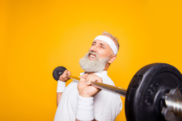 Comic, confident cool grey haired grandpa with humor grimace exercising holding equipment, lifts it...