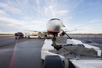 Towing Truck With Commercial Airplane On Airport Runway