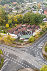 Modern terraced house with central forecourt in a suburb of Germany, with a junction in the foreground, aerial view with drone © Frank