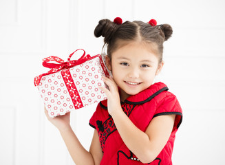 little girl showing gift for chinese new year