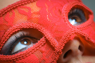 Beauty model woman wearing masquerade carnival mask over Christmas and New Year celebration holiday...