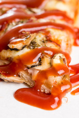 Closeup macro of pizza slice with ham mushrooms and ketchup on the white marble