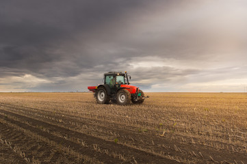 Tractor spreading artificial fertilizers