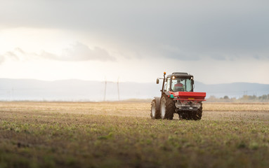 Tractor spreading artificial fertilizers