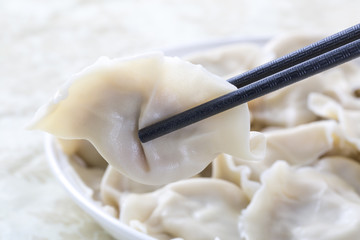 Close-Up Of Chinese Dumplings With Chopsticks.