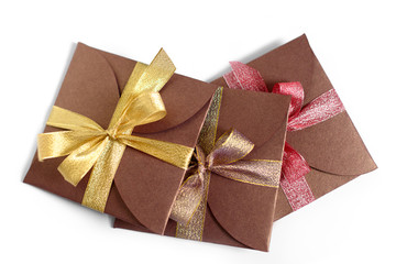 Christmas gifts wrapped in brown paper with the bow top view isolated on white background