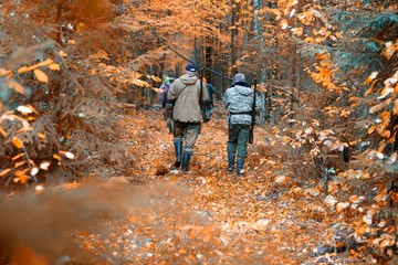 group of hunters during hunting in forest