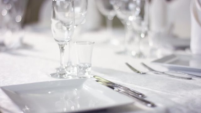 View of waiter hand moving the fork on the banquet table at restaurant
