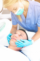 Woman specialist is massaging skin of patient before the procedure