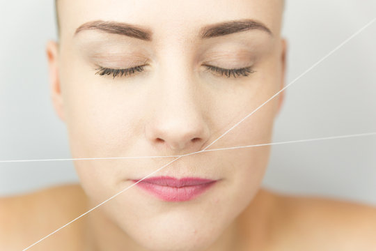 Close-up of female face during correction procedure