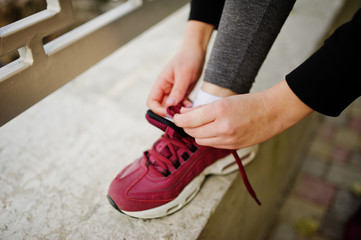 Young girl has the training knit laces on sneakers. Sport, fitness, street workout concept.