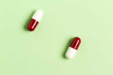 Two red-white capsules with antiboitic