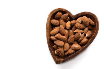 Top view dried almond in wood bowl on white background.