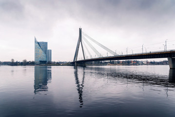 Winter in Riga, cloudy weather and view of the bridge over the river