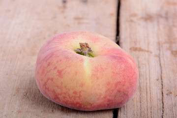 Nectarine fruit on old wooden plate background close up